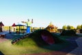 View of empty colorful modern children playground in the Taras Shevchenko Park. City lake in the background. Scenic spring morning