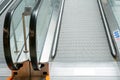 View of an empty escalator without people in a public shopping center. Moving stairs and escalator railings of a major airport or Royalty Free Stock Photo