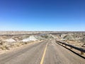 A view of an empty highway winding down into the badlands of Dinosaur Provincial Park, Alberta, Canada Royalty Free Stock Photo