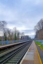 View of an empty platform on the railway on a cloudy day.