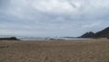 View of empty Praia da Amoreira beach with ocean waves, cliff, stones and golden sand. Rota Vicentina coast, Odemira