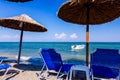 Umbrellas with loungers, chaise are placed next to the coastline Royalty Free Stock Photo