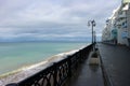 view of empty seaside promenade and sand beach in stormy autumn day Royalty Free Stock Photo