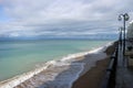 view of empty seaside promenade and sand beach in stormy autumn day Royalty Free Stock Photo