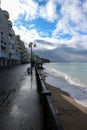 view of empty seaside promenade and sand beach in stormy autumn day Royalty Free Stock Photo