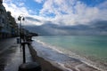 view of empty seaside promenade and sand beach in stormy autumn day Royalty Free Stock Photo