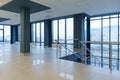 View of an empty spacious hall with columns and panoramic windows. Modern interior design of an empty office. A room with large Royalty Free Stock Photo