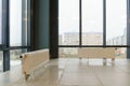 View of an empty spacious hall with columns and panoramic windows. Modern interior design of an empty office. A room with large Royalty Free Stock Photo