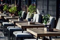 View of empty tables of street cafe or restaurant on summer evening. Epidemic and pandemic. Background Royalty Free Stock Photo