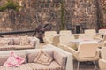 View of empty terrace of open-air cafe with tables and chairs in old town of Budva. Montenegro. Royalty Free Stock Photo