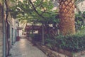 View of empty terrace of open-air cafe with tables and chairs in old town of Budva. Montenegro. Royalty Free Stock Photo