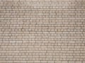 View of empty, white brick wall background with copy space. A deteriorating brick wall outdoors in sunlight Royalty Free Stock Photo