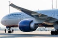 View on engine and cockpit of passenger jet aircraft Boeing 777-300ER of Aeroflot Airlines. Two workers check plane`s chassis. Royalty Free Stock Photo