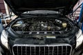 View of engine and other parts under the open hood of a car Royalty Free Stock Photo