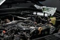 View of engine and other parts under the open hood of a car Royalty Free Stock Photo