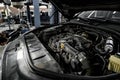 View of engine and other parts under the open hood of a car Royalty Free Stock Photo