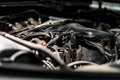 View of engine and other parts under the open hood of a car Royalty Free Stock Photo