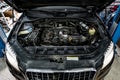 View of engine and other parts under the open hood of a car Royalty Free Stock Photo