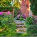 View of an entrance with bushes and plants. Stone stairs in backyard surrounded by tropical plants and flowers. Stairs Royalty Free Stock Photo