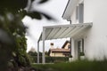 View of entrance of luxury villa with white canopy.