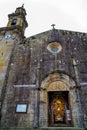 View of the entrance of the Rianxo church where you can see the lights, sculptures and the priest and his parishioners