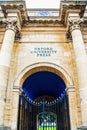 View of an entrance to Oxford University Press with pillars and and a courtyard seen through an iron gate
