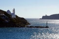 View of the entrance to the port of Ios with its lighthouse and the church of Saint Irene Royalty Free Stock Photo