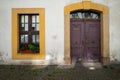 A view of the entrance to the townhouse. A large ornate wooden door and on the left a large sized window. Royalty Free Stock Photo