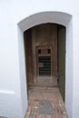 Old wooden door and brick walk outside historic fortress