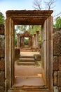 View through temple entrance in ruins of Banteay Srei, Cambodia, to the green forest.