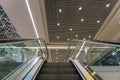 View of the escalator in the public shopping center. Moving stairs and escalator railings of a major airport or subway Royalty Free Stock Photo