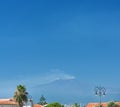 Etna in the distance against a blue sky