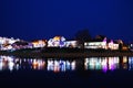 View of the evening city, the reflection of houses in the water