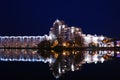 View of the evening city, the reflection of houses in the water