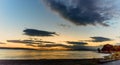 View of the evening ocean with lights of ships, mountains and cl