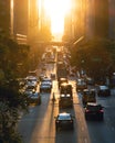 View of evening rush hour traffic traveling crosstown on 42nd Street through Manhattan New York City with sunlight shining between