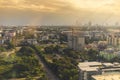 View of expanding city, changing environment. In the evening, the sun shines through cloudy sky and rain from the tower Royalty Free Stock Photo