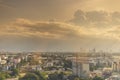 View of expanding city, changing environment. In the evening, the sun shines through cloudy sky and rain from the tower