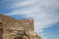 View at the exterior fortress at Mogadouro Castle, senior tourist couple going down the stairs, iconic monument building,