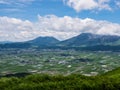 View of extinct volcanoes with village near foothills.