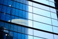 View of the facade of a modern business center with reflection of a skyscraper Royalty Free Stock Photo