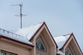 View of the facade of a modern concrete building or office center. The roofs of the buildings are covered with snow and ice after Royalty Free Stock Photo