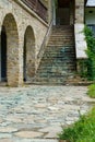 view of the facade of an old house with a stone steps and porch and arches Royalty Free Stock Photo