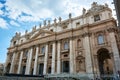 A view of the facade of St. Peter`s Basilica at Saint Peter`s Square in the Vatican City in Rome, Italy, under blue cloudy sky o Royalty Free Stock Photo