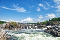 View of the Falls of the Potomac River in Virginia. A stormy stream of water among the rocks under the blue sky Royalty Free Stock Photo