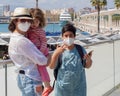 View of a family travelling in pandemic times using masks