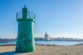 View of the famous basilica cattedrala di san nicola pellegrino behind a lighthouse in the italian city Trani....IMAGE Royalty Free Stock Photo