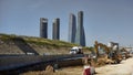 View of the famous four towers of Madrid with machinery working on the construction of a road