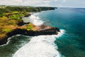 View of the famous Golden beach between black volcanic rocks on the banks of the Gris-Gris river, La Roche qui pleure in Mauritius