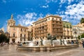 Valencia, Spain - 07/24/2019: A Famous El Miguelete Tower and NeptuneÃÂ´s Fountain, La Plaza De La Virgen.